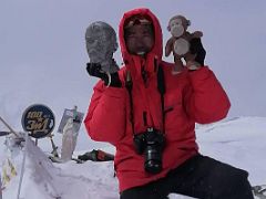 14C Lal Sing Tamang holds Dangles and the bust of Lenin on the Lenin Peak summit 7134m